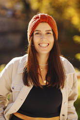 Happy young woman with knit hat and jacket - DAWF02214