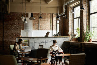 Man and teenage girl spending leisure time at modern cafe - DSHF00065