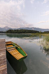 Boat moored by jetty at Lake Faak, Carinthia, Austria - DAWF02248