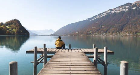 Tourist looking at mountains on pier Interlaken, Switzerland - JAQF00912