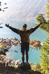 Carefree man with arms outstretched at Interlaken, Switzerland - JAQF00923