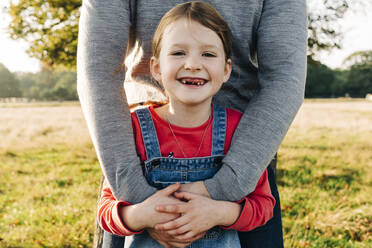 Happy daughter with father in park - ASGF01768