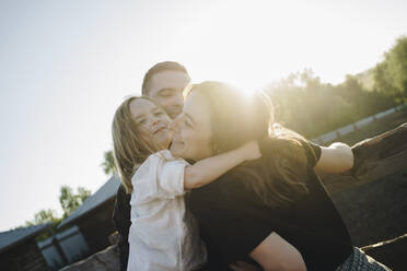 Girl hugging parents at farm - SEAF00148