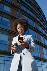 African American entrepreneur browsing cellphone - CAVF95332