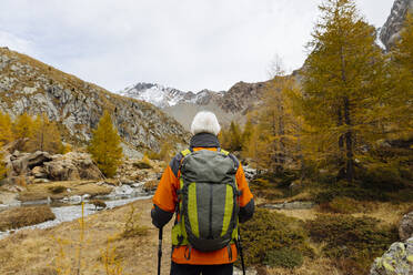 Senior backpacker hiking at Rhaetian Alps, Italy - MRAF00789