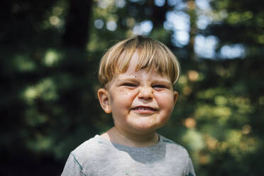 Playful boy making face on sunny day - ACTF00152