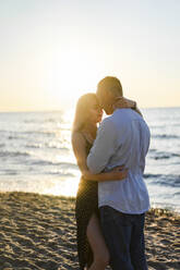 Loving young couple embracing each other at beach - SSGF00317