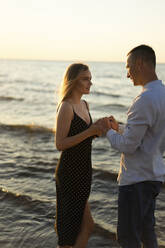 Junges Paar hält Hände am Strand - SSGF00324