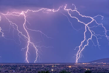 Lightning bolts striking Prescott area in the distance with the town of Chino Valley just north of Prescott Town in the foreground, Arizona, United States of America, North America - RHPLF20874