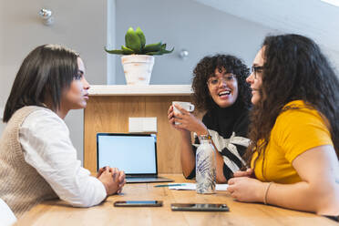 Coworkers discussing in business meeting at office - JAQF00999