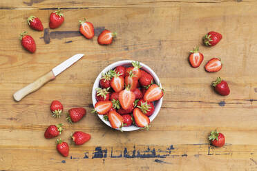 Fresh ripe strawberries lying on wooden surface - GWF07281