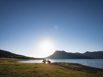 Motor home at lakeshore at sunset - LAF02723