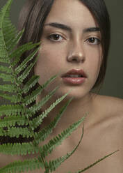 Seductive shirtless woman with fern twig - JBYF00050