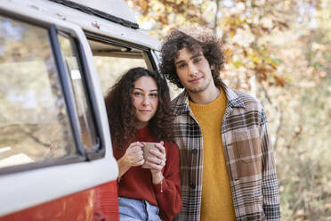 Young couple at campervan in autumn forest - EIF02465