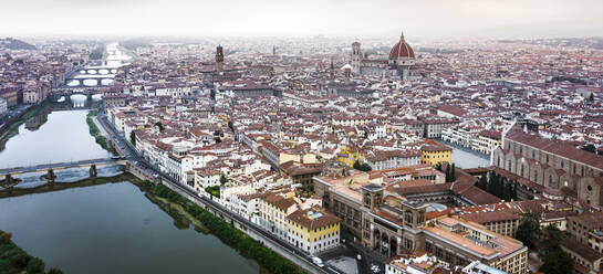 Aerial view of Florence downtown along the Arno river, view of Santa Maria del Fiore cathedral, Tuscany, Italy. - AAEF13526