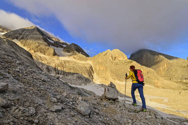 Female climber ascending ridge of Marmolada mountain - ANSF00096