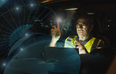 Engineer touching futuristic graph in car - UUF25205
