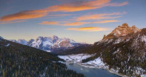 Sunrise over the snowy woods surrounding Lake Misurina and Sorapis, aerial view, Dolomites, Belluno province, Veneto, Italy, Europe - RHPLF20932