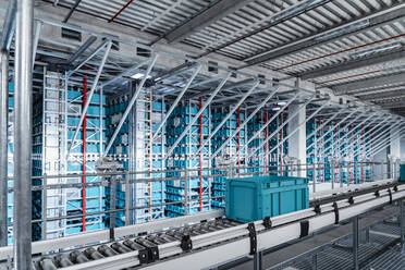 Container on conveyor belt at automated warehouse - DIGF16999