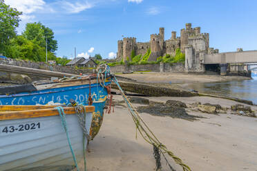 View of Conwy Castle, UNESCO World Heritage Site, and boats on the shore, Conwy, Conway County Borough, Wales, United Kingdom, Europe - RHPLF21139