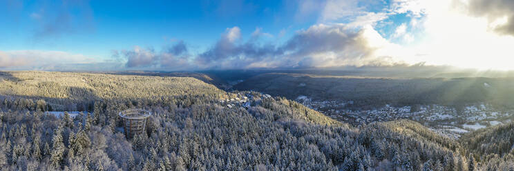 Germany, Baden-Wurttemberg, Bad Wildbad, Aerial view of Black Forest range at winter sunrise with town in background - WDF06700