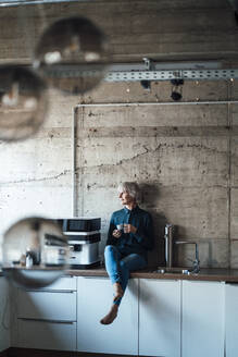 Thoughtful businesswoman sitting at cafeteria - JOSEF06000