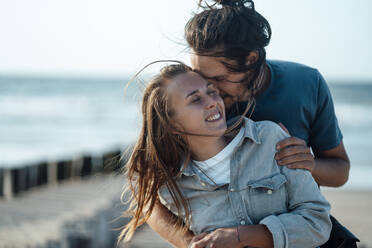 Affectionate couple embracing at beach - GUSF06621