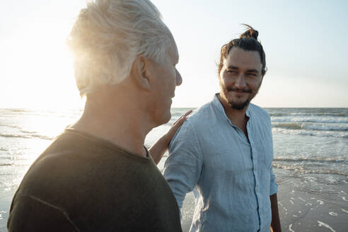 Smiling man looking at father - GUSF06639