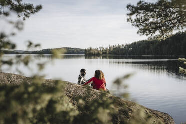 Girlfriend spending leisure time with boyfriend at lakeshore during weekend - MASF27208