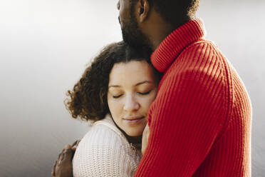 Young woman with eyes closed embracing boyfriend - MASF27217