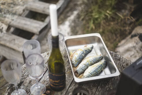 High angle view of fish and beer at table - MASF27595