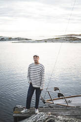 Portrait of man standing with hand in pocket against sea - MASF27606