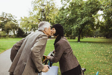 Senior couple kissing on mouth in park during vacation - MASF27886