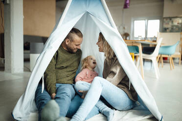 Family sitting together in tent at home - GUSF06671