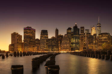 Manhattan skyscrapers lit up at dawn. - MINF16468