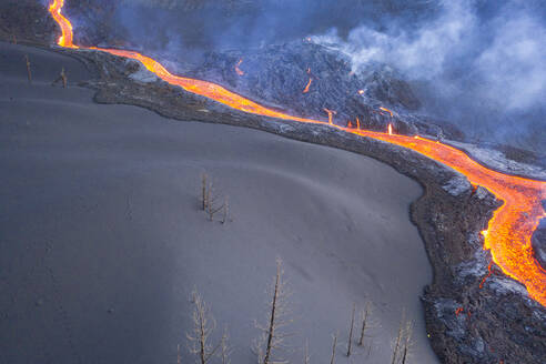 Aerial top down view of lava floating down the Volcan Cumbre Vieja, a volcano during eruption near El Paraiso town, Las Manchas, La Palma Island, Canary Islands, Spain. - AAEF13590