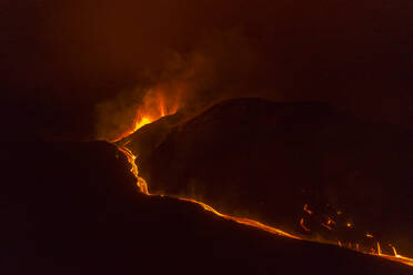 Luftaufnahme der Lava, die nachts den Vulkan Cumbre Vieja hinunterfließt, ein Vulkan während eines Ausbruchs in der Nähe der Stadt El Paraiso, Las Manchas, Insel La Palma, Kanarische Inseln, Spanien. - AAEF13602