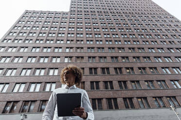 Businessman holding tablet PC at Potsdamer Platz - GUSF06708