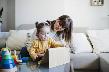 Mother and daughter with tablet PC on table - EBBF05079