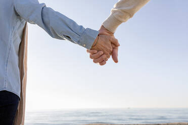 Couple holding hands at beach - EIF02562