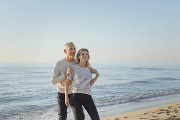 Smiling couple near seashore at beach - EIF02597