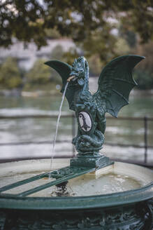 Switzerland, Basel-Stadt, Basel, Dragon sculpture decorating small drinking well - KEBF02081