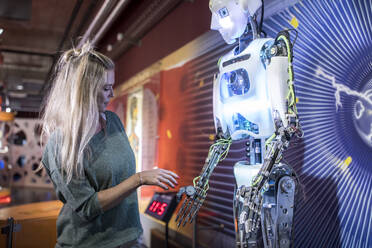 Technician doing handshake with human robot at workshop - WESTF24743