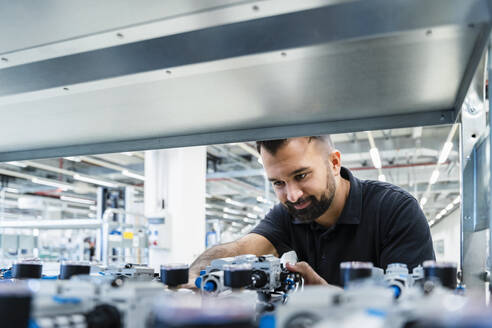 Engineer checking electrical equipment at automated industry - DIGF17252