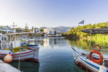 Greece, Crete, Sissi, Boats moored in marina of coastal village - THAF03001