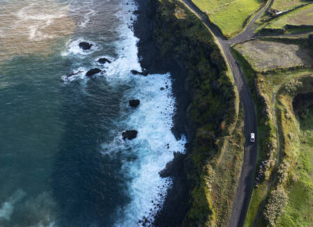 Portugal, Azores, Ribeira Grande, Drone view of dirt road stretching along edge of Sao Miguel Island - WWF05921