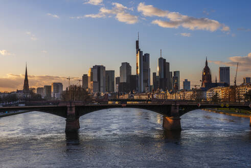 Deutschland, Hessen, Frankfurt, Ignatz-Bubis-Brücke in der Abenddämmerung mit Skyline der Innenstadt im Hintergrund - RUEF03436