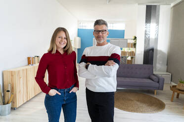 Businesswoman with hands in pockets standing by colleague in office - GIOF14573