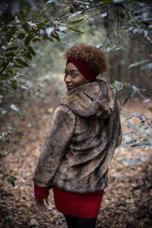 Portrait beautiful young woman walking in autumn woods - CAIF31808