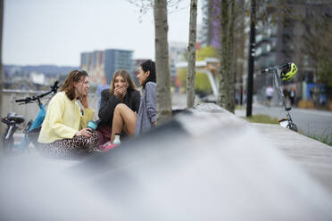 Young women friends talking in city - CAIF31898